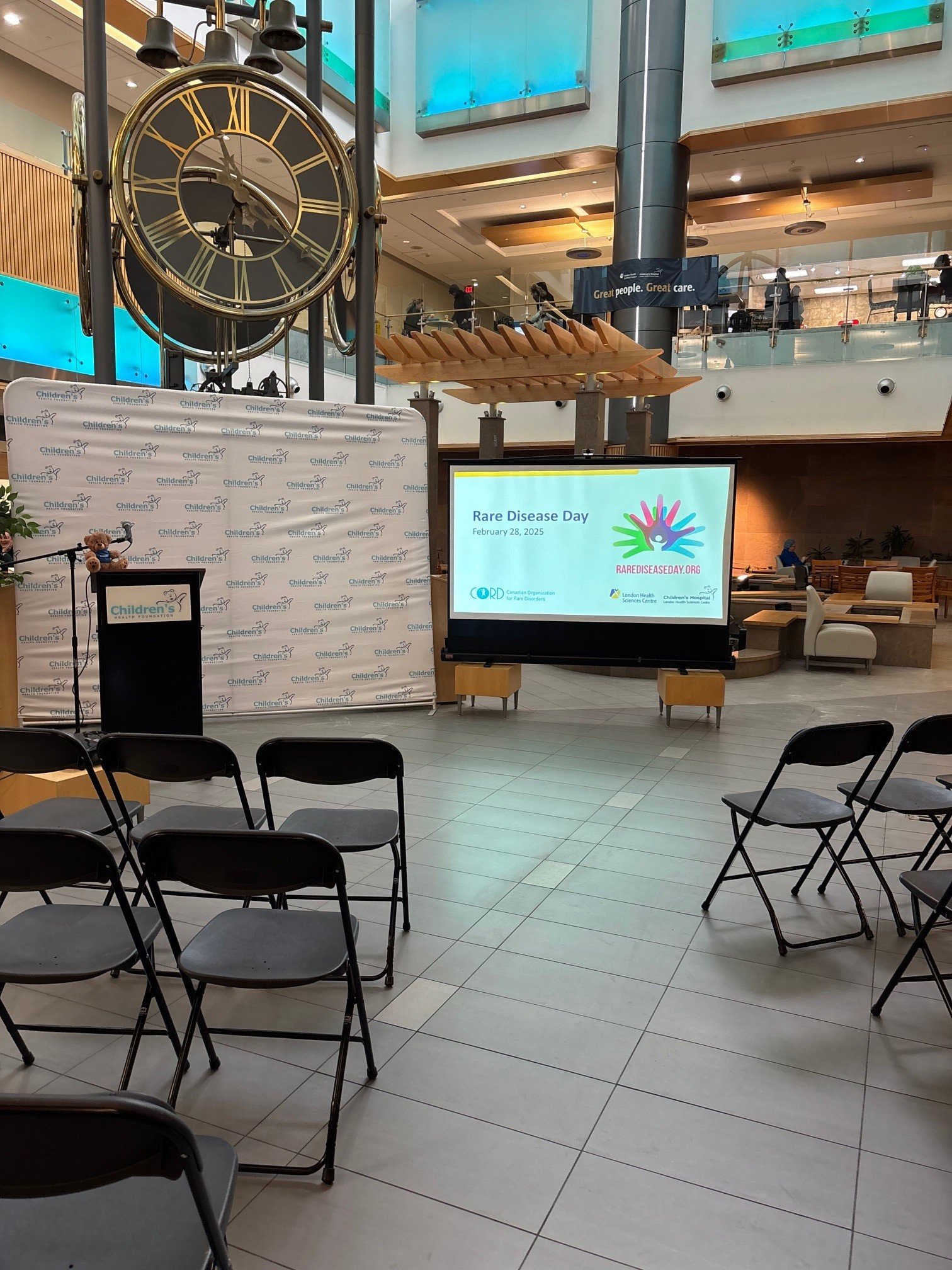 Podium and projection screen set-up for Rare Disease Day 2025 at London Health Sciences Centre. Photo courtesy of Cara Grobbecker.